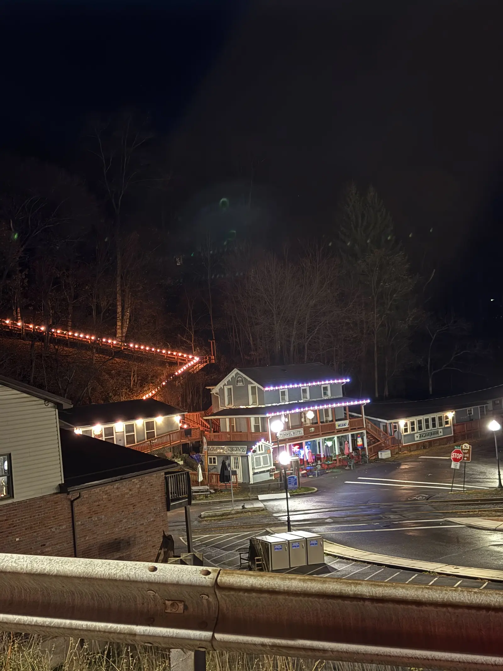 Hillside rail town lit up at night for holiday railbike rides