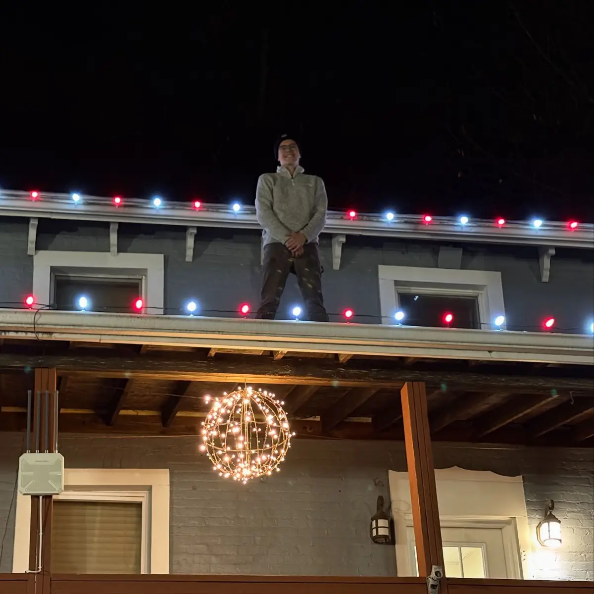 Crew installing C9 lighting along a rooftop